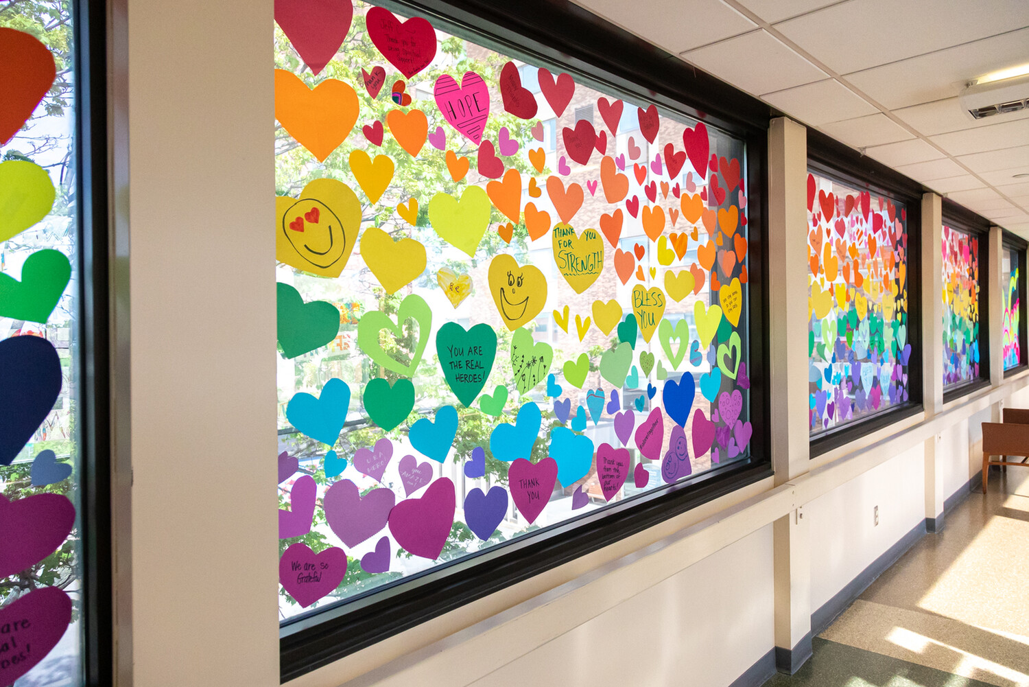 Colorful, heart-shaped messages of encouragement for frontline health care providers cover the windows at M Health Fairview Bethesda Hospital
