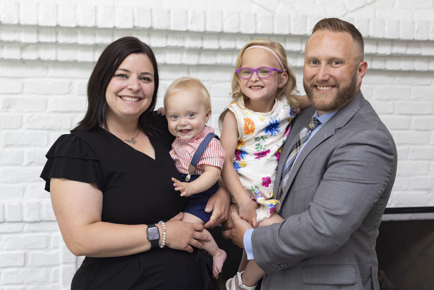 a photo of the Gand family, with Kari holding Louie and Tony holding Lily