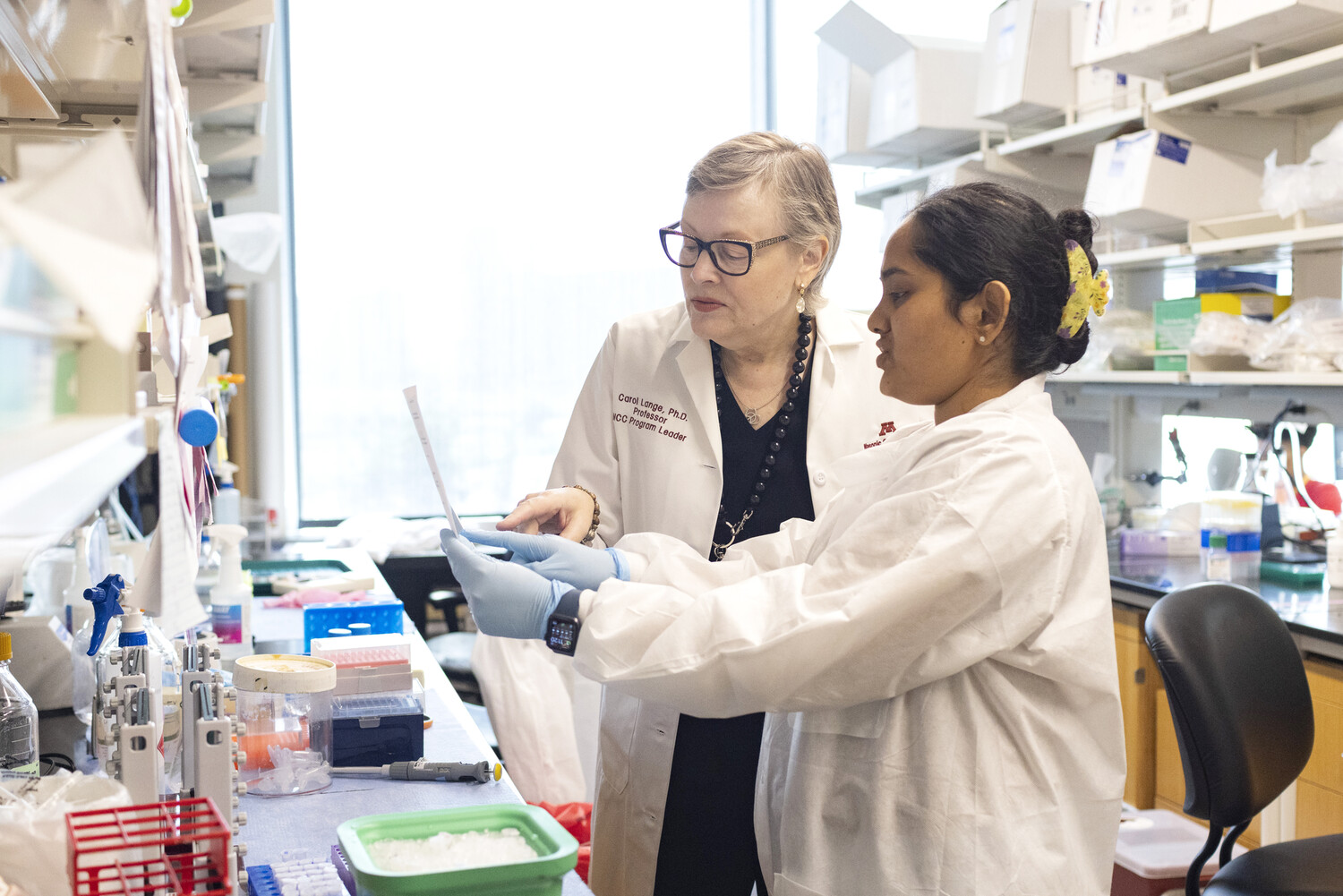 Carol Lange and a researcher in her lab