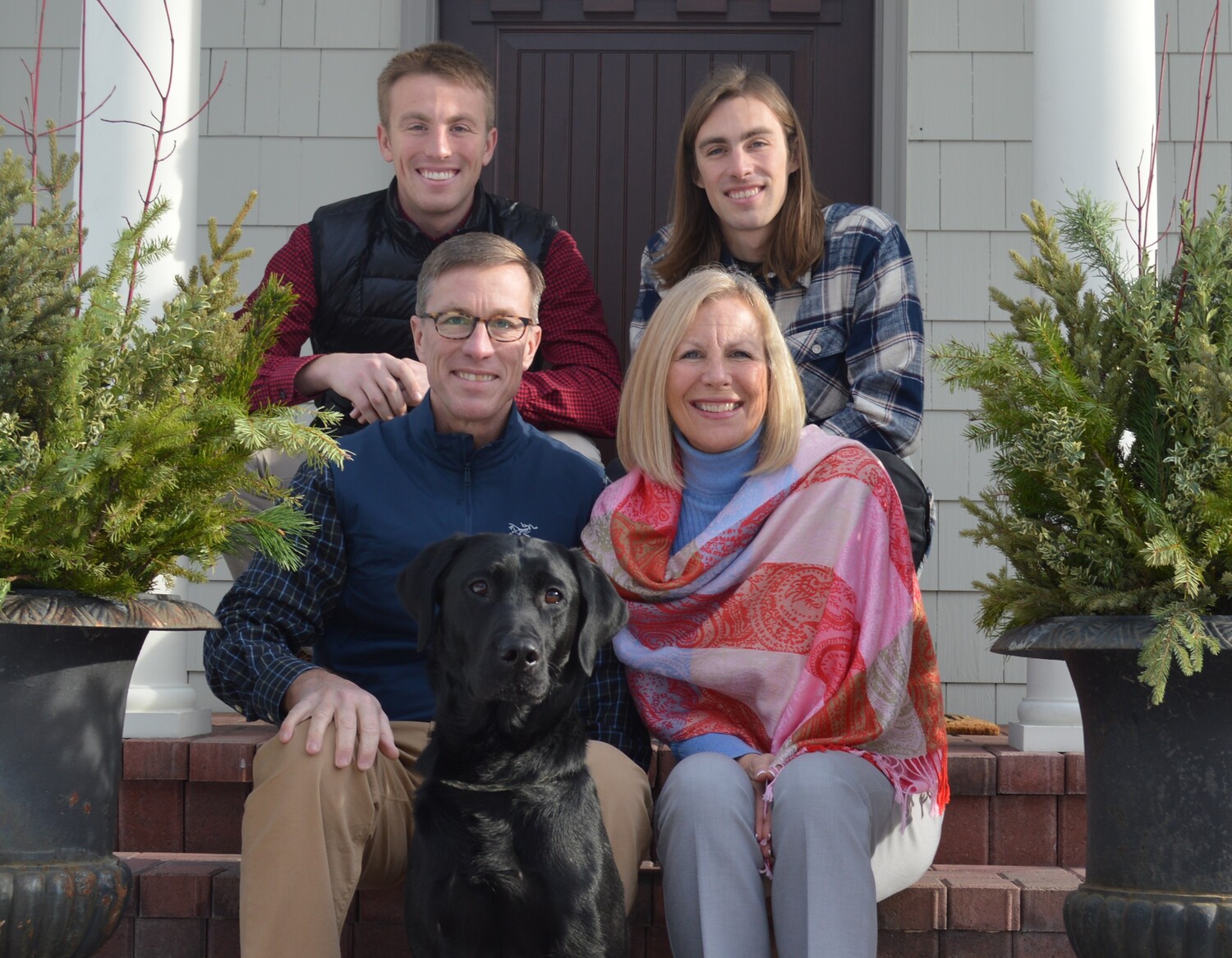 Dean Friesen sits with his family and their dog