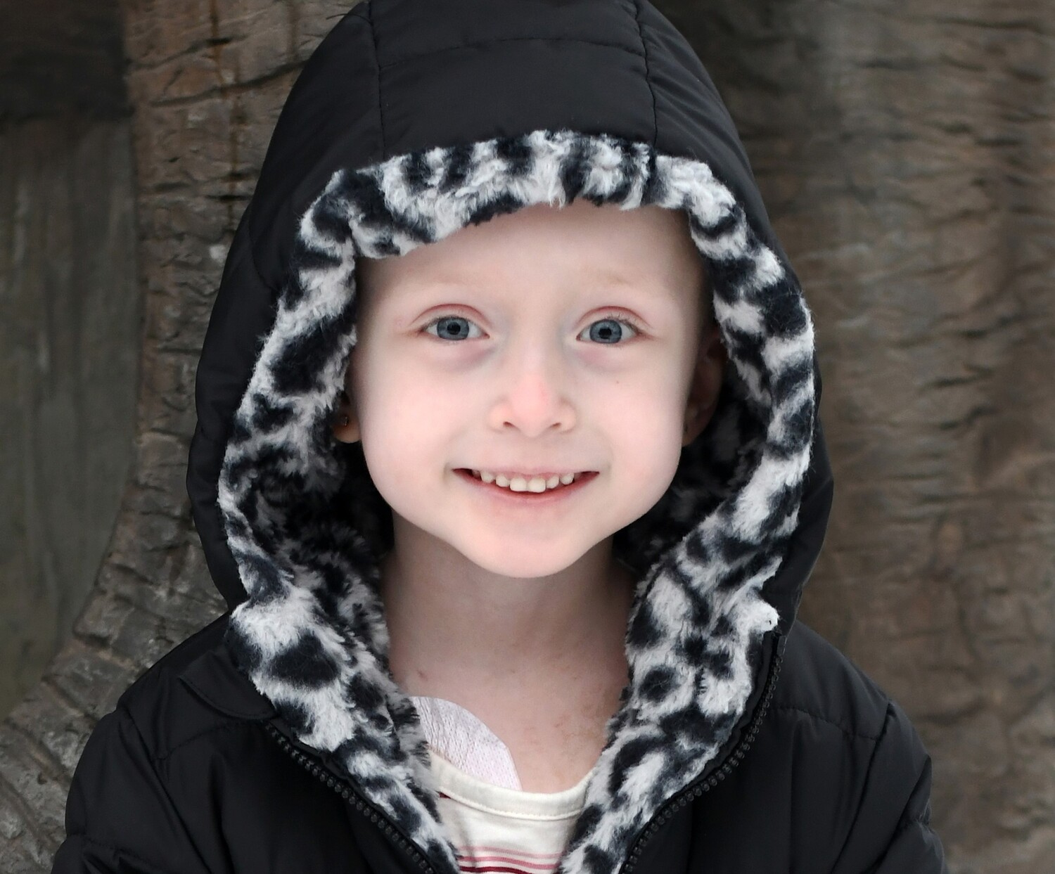 A photo of Celia Grace Hamlett smiling while wearing a black winter coat