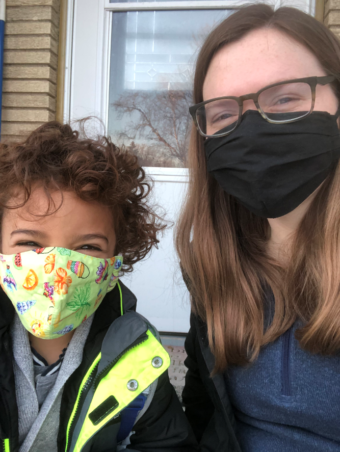 Marcos Marchiando and his CovidSitter, Carleigh Rand, pose for a photo while wearing facemasks