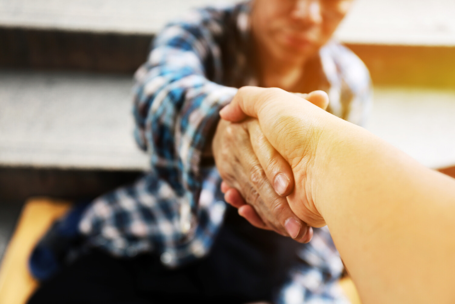 Stock photo of two people shaking hands in a clinical setting